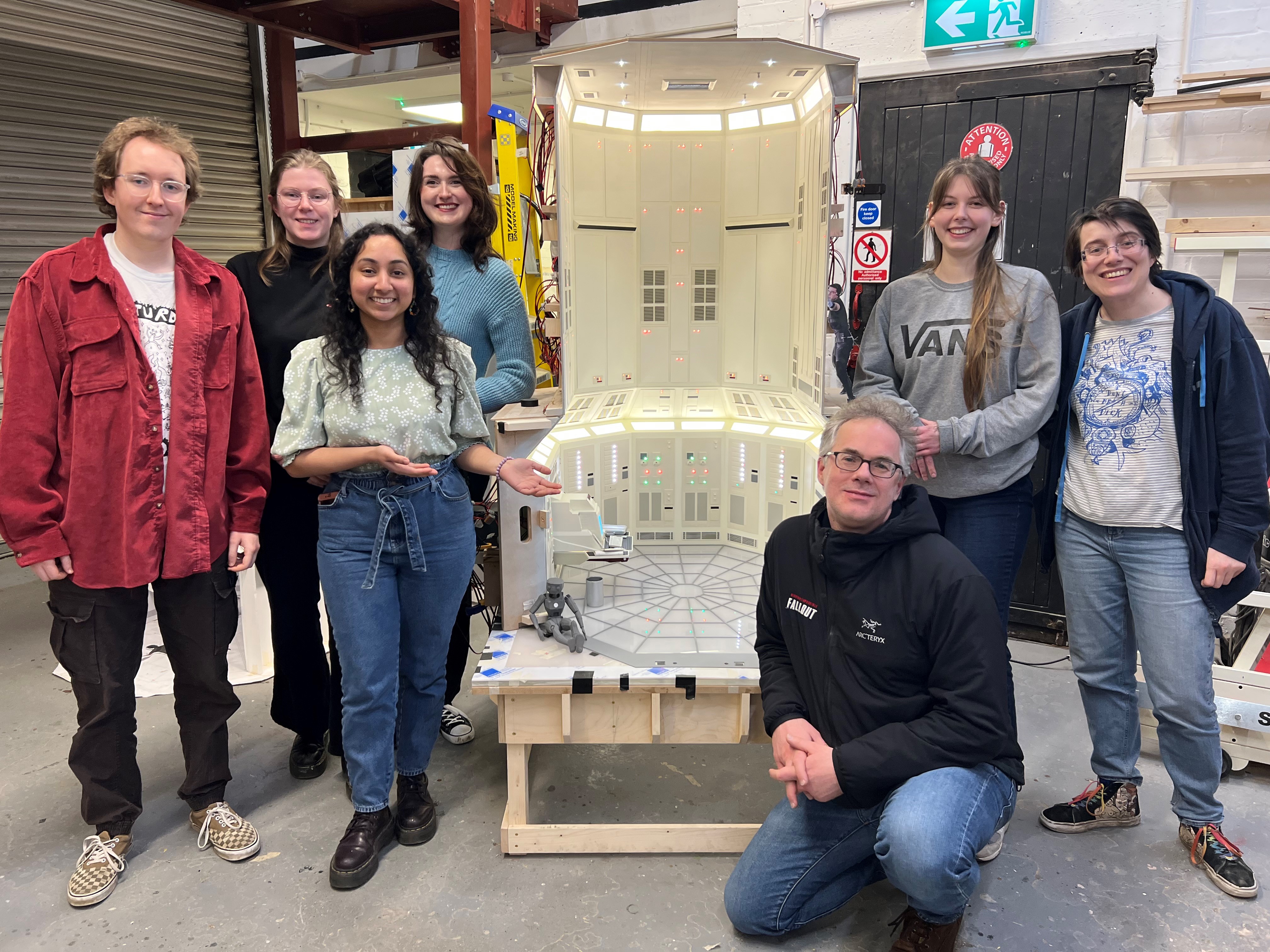 Eddie Hamilton and students next to Mission Impossible model