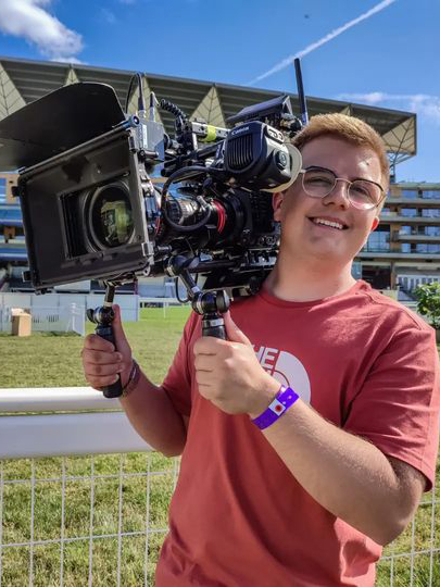 Freddie holding camera