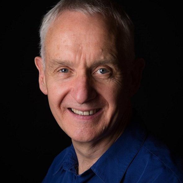 Headshot image of John Archer in colour against black